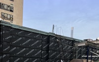 Low-angle image of a building's roof-to-wall transition.
