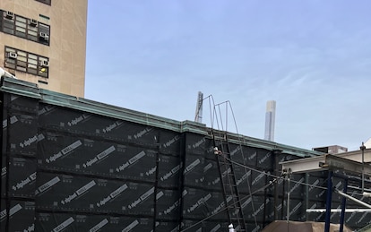 Low-angle image of a building's roof-to-wall transition.