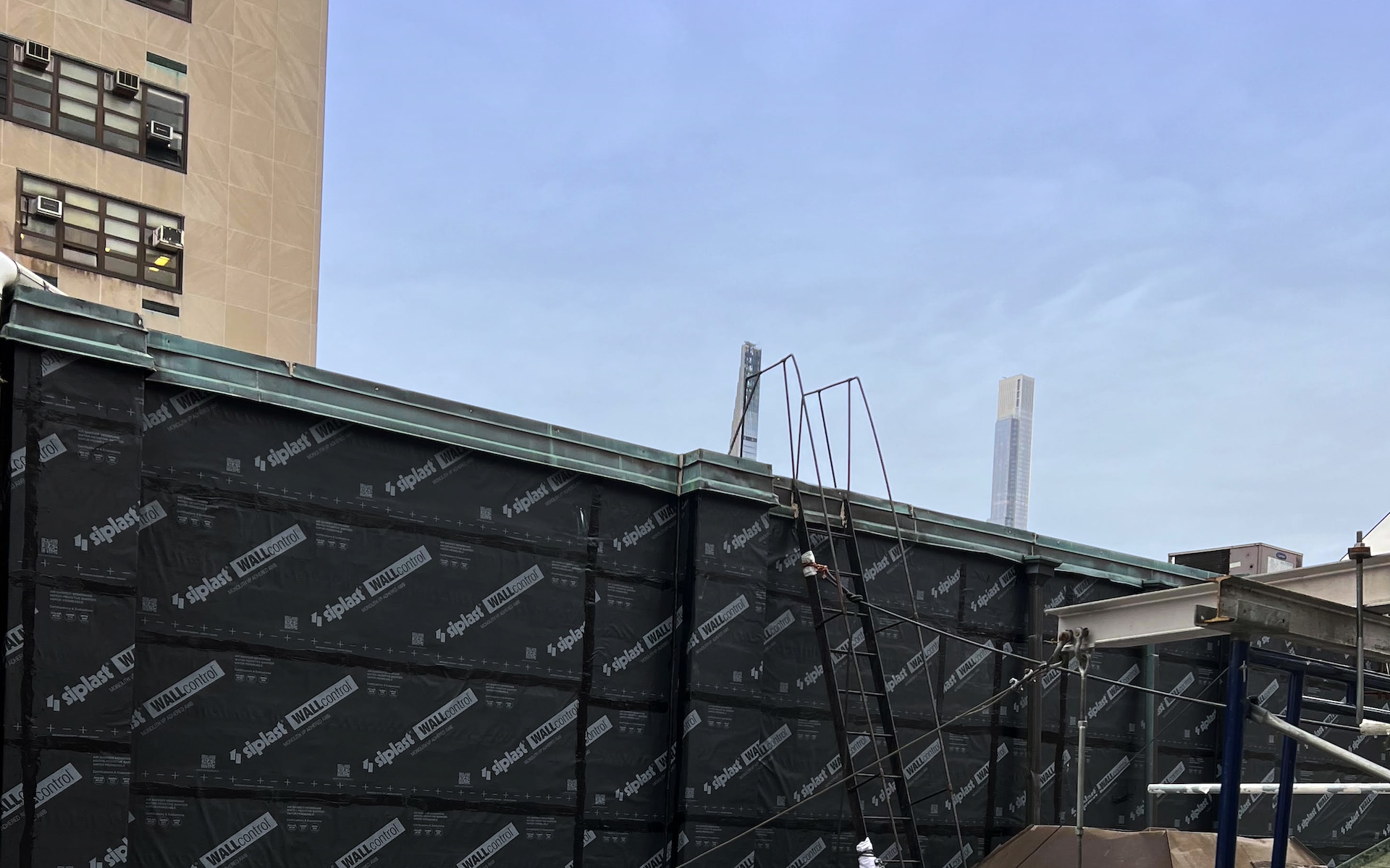 Low-angle image of a building's roof-to-wall transition.