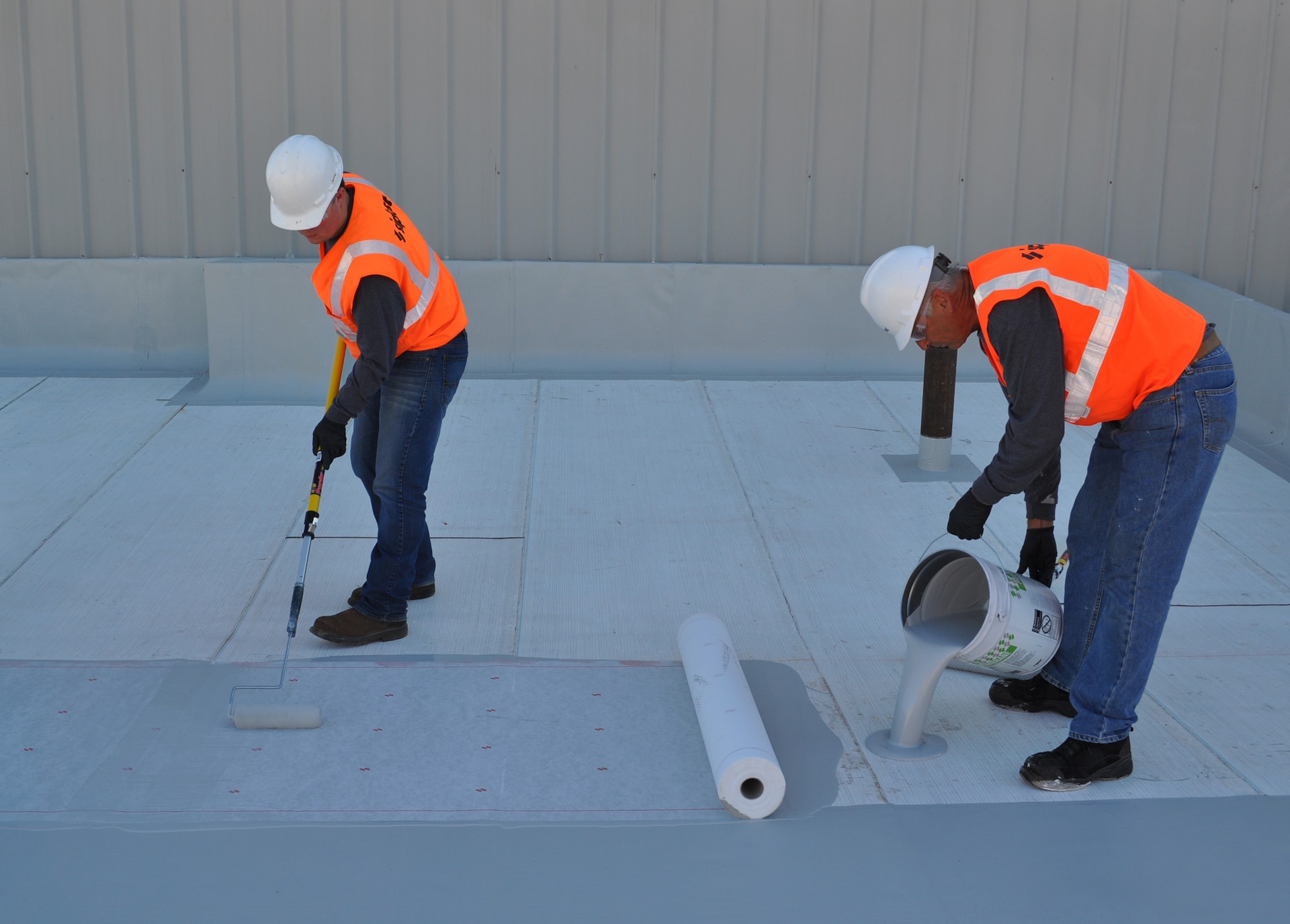 Roof membrane being rolled out