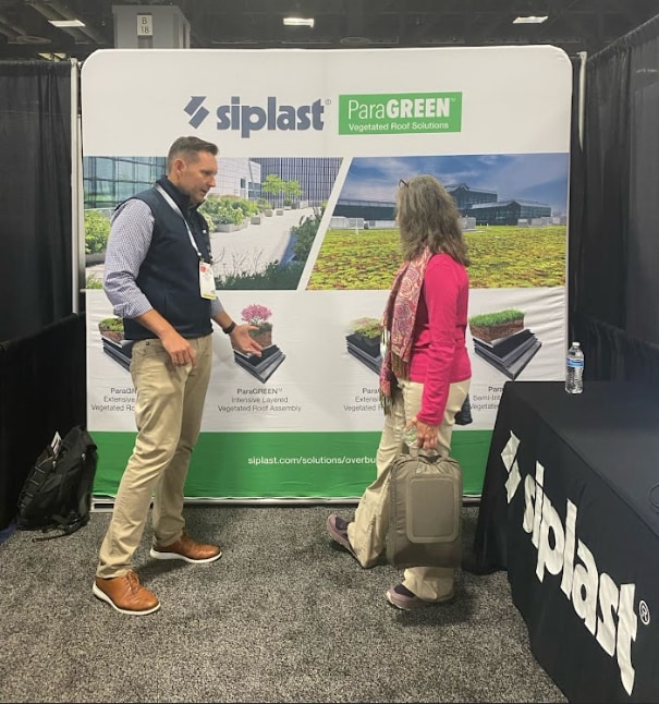 Rick Kile talking to a conference attendee about Siplast ParaGREEN