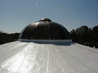 Roofer inspecting materials in warehouse.