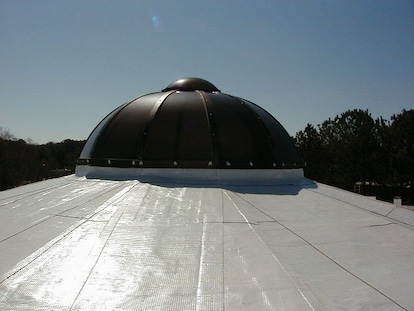Roofer inspecting materials in warehouse.