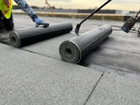 A team of roofers works to install GAF SBS-Modified Bitumen