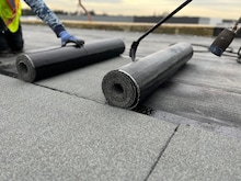 A team of roofers works to install GAF SBS-Modified Bitumen