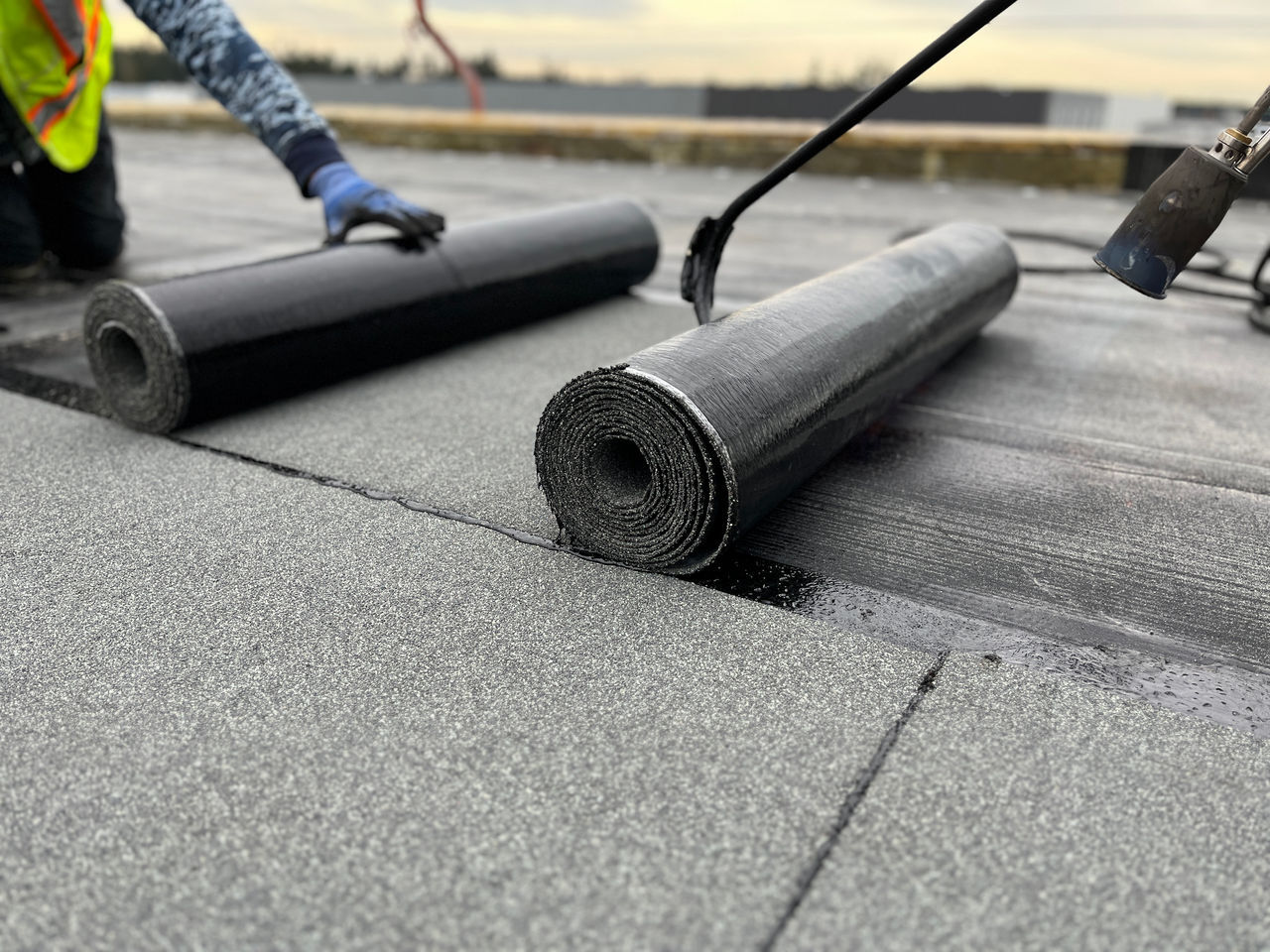 A team of roofers works to install GAF SBS-Modified Bitumen