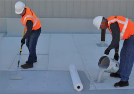 Two Siplast workers applying a Parapro Roof Membrane with Pro Fleece