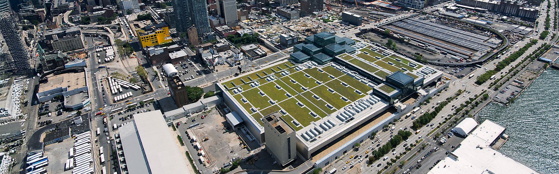 A green roof with trees, bushes, shrubs, and sustainable amenity hardscape on a commercial building.