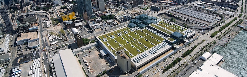 A green roof with trees, bushes, shrubs, and sustainable amenity hardscape on a commercial building.