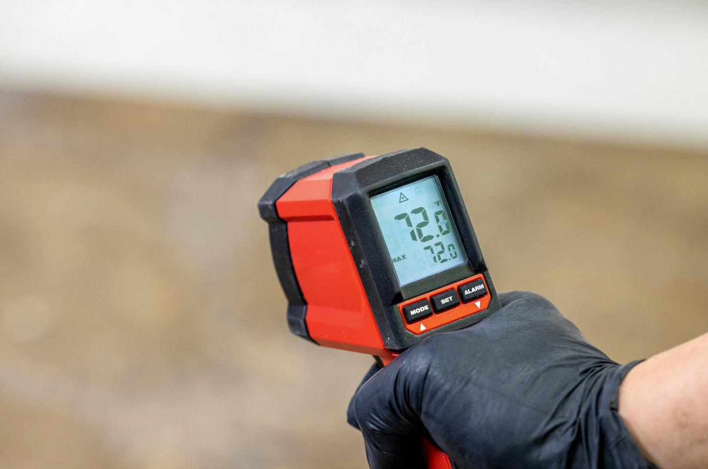 a contractor using a laser temperature gun A Contractor using a laser temperature gun