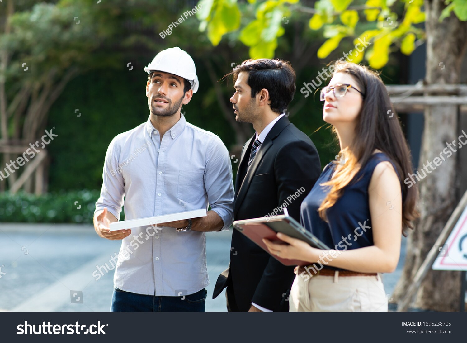 Three professionals discuss a project.