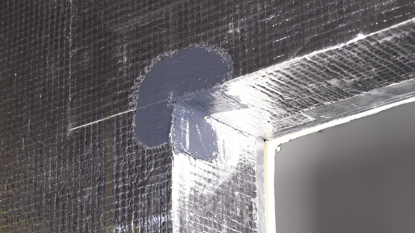 a corner of educational building with wallcontrol reinforced aluminum flashing and stpe flashing from an awb system. A corner of educational building with WALLcontrol reinforced aluminum flashing and STPE flashing from an AWB system.