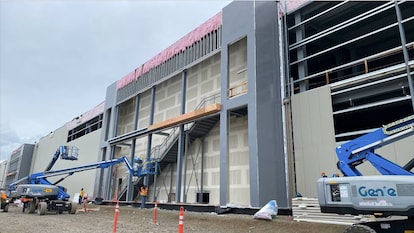 Construction equipment near the outside of an educational building structure