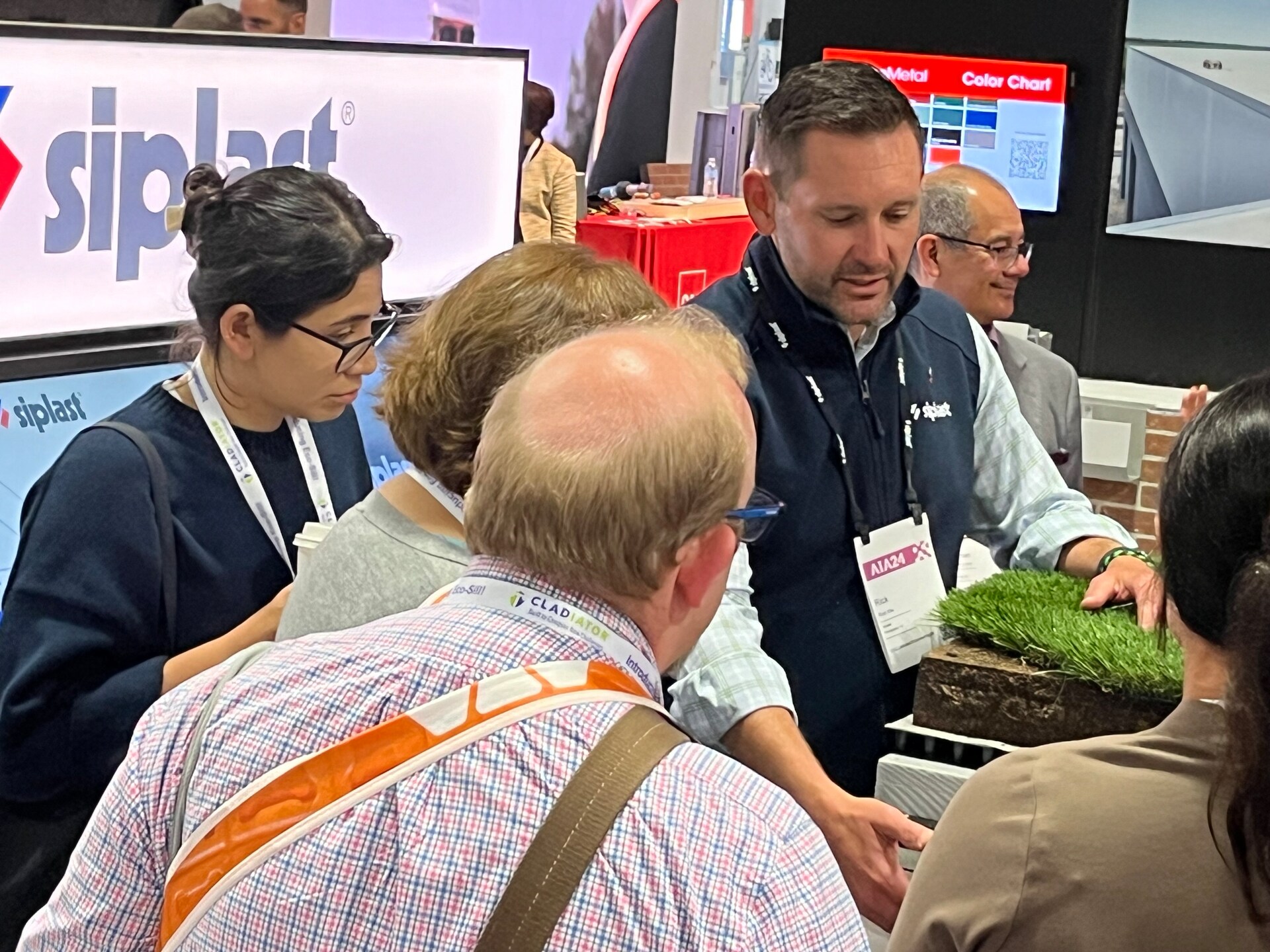 Rick Kile smiles, wearing a dark blazer and plaid shirt