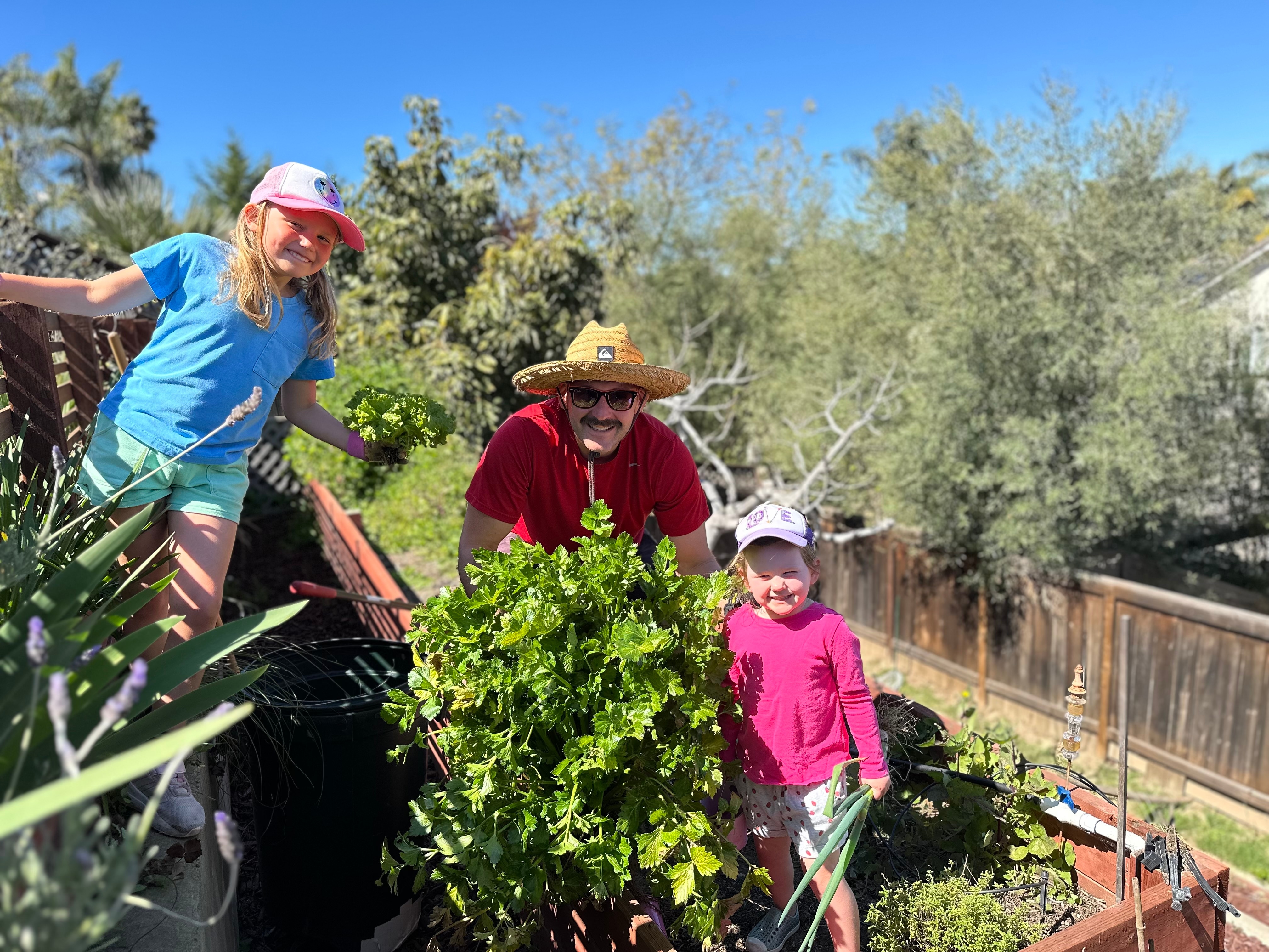 rick kile in the garden with his daughters Rick Kile in the garden with his daughters