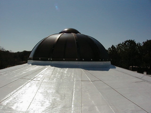 Roofer inspecting materials in warehouse.